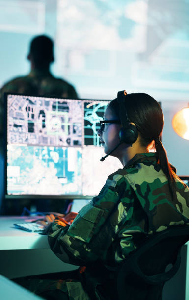 istock Military control room, computer screen and woman in surveillance, headset and tech for communication. Security, global digital map and soldier at monitor in army office at government command center. 1705832705