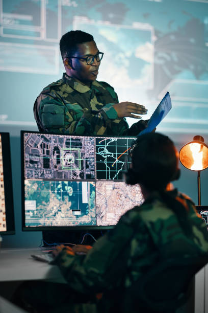 istock Military control room, computer and woman with team leader, headset and tech in communication. Security, surveillance management and soldier with black man in army office at government command center 1705832707