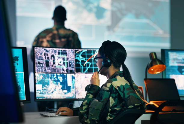 istock Military command center, computer screen and woman in surveillance, headset and tech for communication. Security, world satellite map and soldier at monitor in army office at government control room. 1705832714