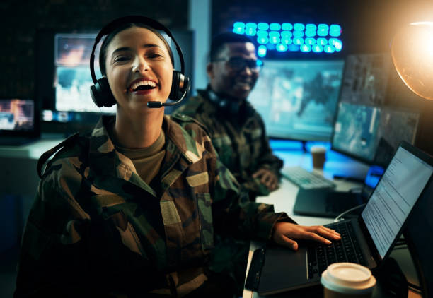istock Army control room, computer and woman in smile, headset and tech communication. Security, global surveillance and portrait of soldier laughing at desk in military office at government command center. 1705832721