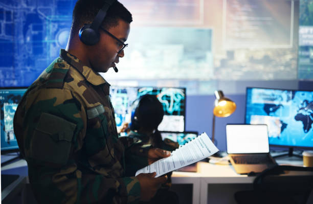 istock Control room, military documents and people on computer for surveillance, tracking operation and national security. Army, government report and soldiers for cybersecurity, communication and network 1705832731