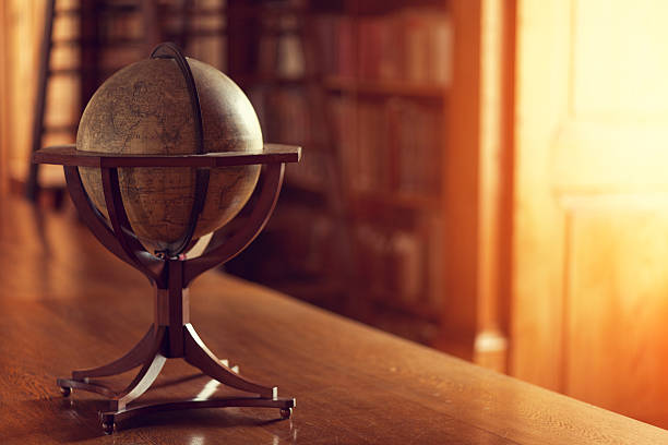 Library interior Library interior: Old globe, defocused books on the bookshelves in the background. desktop globe stock pictures, royalty-free photos & images