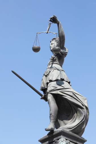 300 year old statue of Lady Justice overseeing the Well of Justice  at Frankfurts Roemer Square / Germany