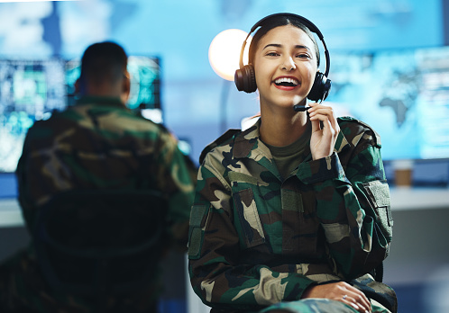 Portrait, headset and a woman in a military control room for strategy as a soldier in uniform during war or battle. Face, smile and young army person in an office for support, surveillance or service