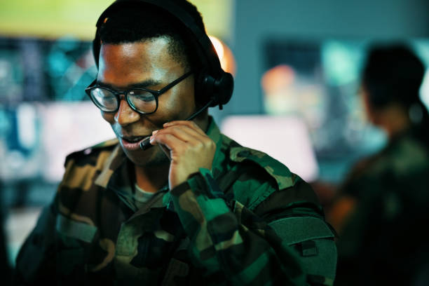 istock Control room man, surveillance and military communication, army risk dispatch or security telecom advice. Headset, 911 emergency consultation and African soldier consulting on intel support service 1705838672