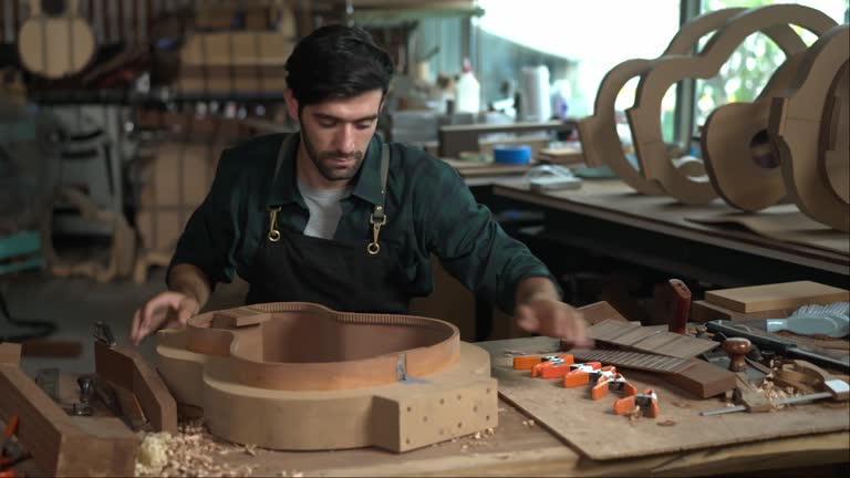 Luthier Inspects Kerfin Lining on Guitar Body