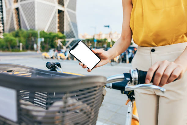 istock An Asian business woman rents a public bicycle using a mobile app while commuting, 1705871471