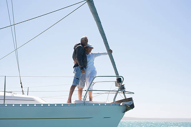 Mature couple hugging on deck of sailboat  sailing couple stock pictures, royalty-free photos & images