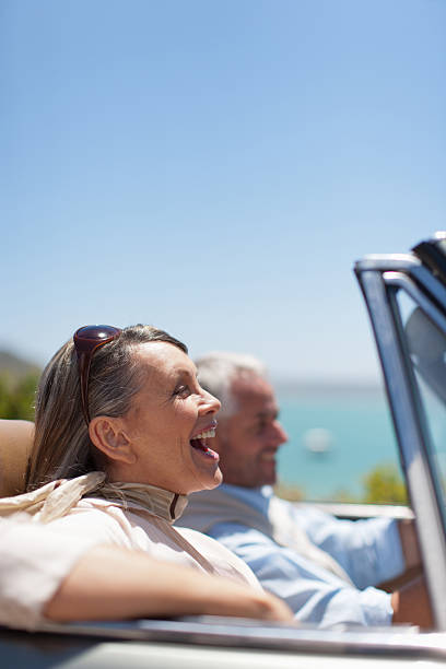 Mature couple driving in convertible  convertible photos stock pictures, royalty-free photos & images