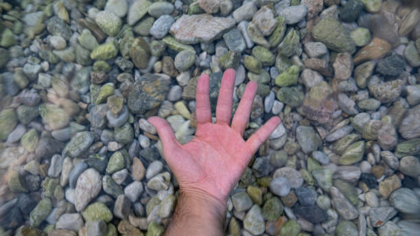 istock hand visible in the clear sea water 1705894105