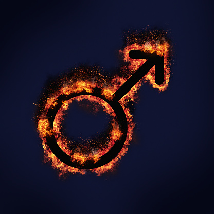 Universal symbol for male, burning on a blue-black background with copy space. The symbol also represents the planet Mars.