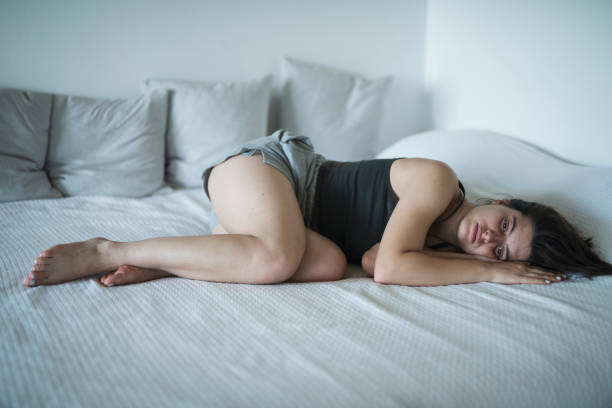 istock Young woman laying in bed feeling sad and distraught. 1705907054
