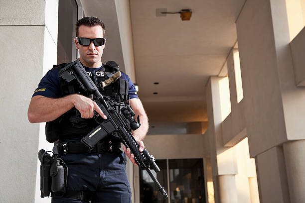 istock Police officer holding rifle 170590916