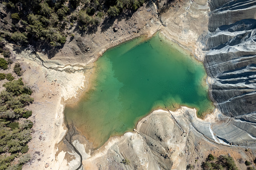 Drone aerial scenery of a toxic lake of an abandoned copper mine. Environmental pollution concept. Troodos Cyprus