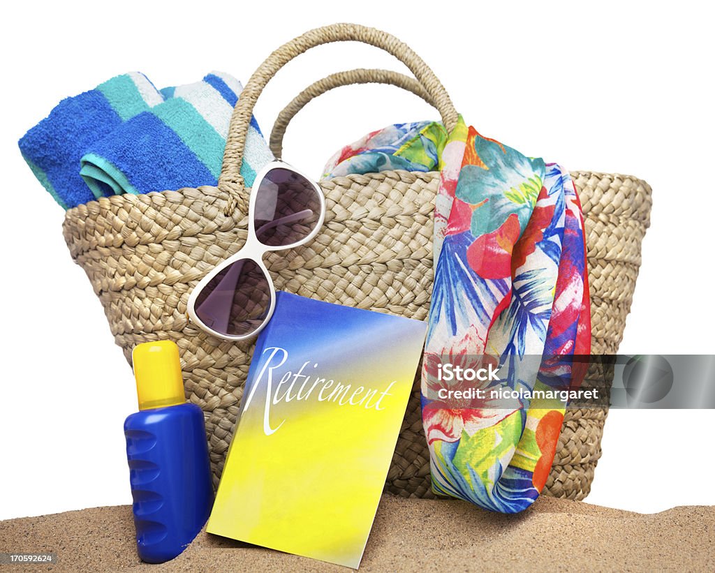 Retirement Concept: on white Retirement book and beach accessories. Isolated on white.  The cover of the book is the photographers design. Beach Bag Stock Photo