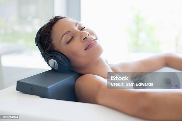 Woman Listening To Music In Bathtub Stock Photo - Download Image Now - 25-29 Years, Adult, Adults Only