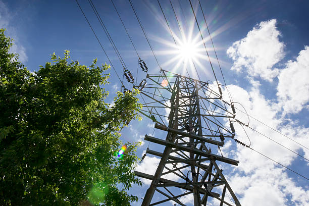 High Voltage Lines and Bright Sun Illustrate Summer Power Needs stock photo