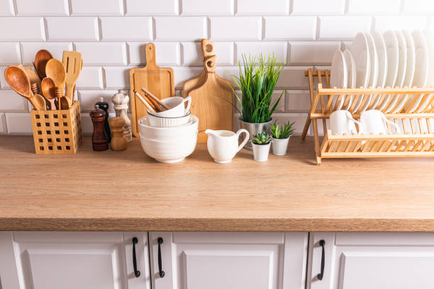 istock Beautiful kitchen background with different items and kitchen utensils made of eco-friendly materials. wooden countertop, white brick wall. 1705941628