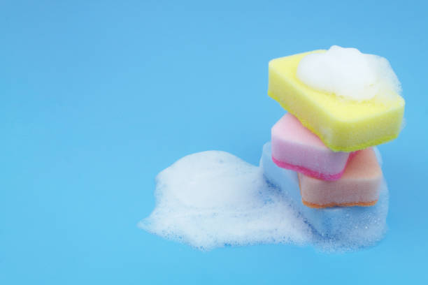 istock Many different sponges with foam on blue background. 1705962291