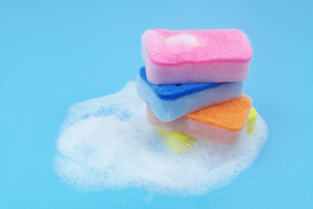 istock Many different sponges with foam on blue background. 1705962317