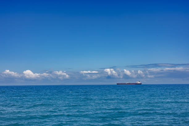 istock Cargo ship on the horizon off the coast of Sicily 1705962888