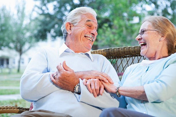 istock Senior couple sitting together on patio laughing 170596893