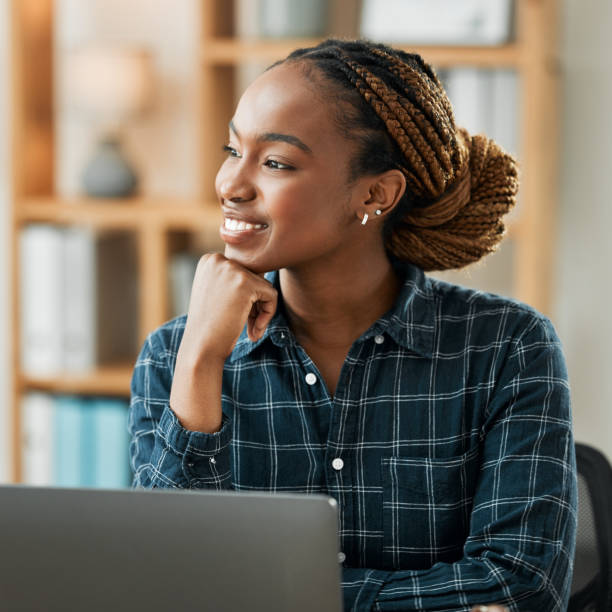 istock Woman, thinking and computer for work from home opportunity, copywriting ideas and planning goals. Young african person, happy freelancer or writer on laptop, business vision and brainstorming online 1705973309