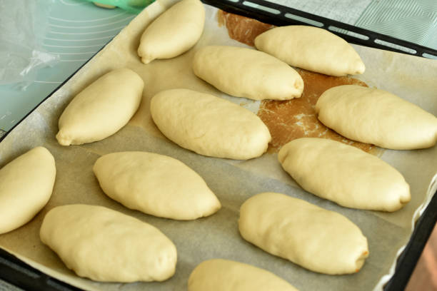 istock Top view of filled pies lying on a baking sheet before baking. 1705989323