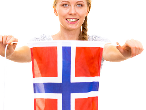 Blonde teenage girl holding flag of Norway. Education. Norwegian language school. Visit Norway concept.