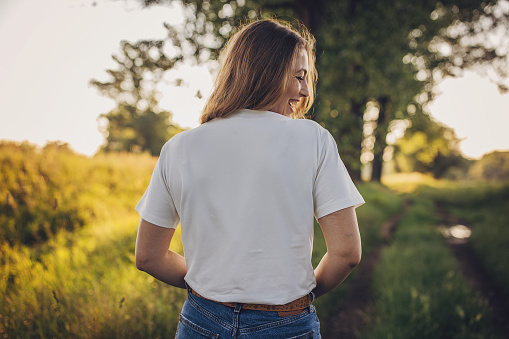 One woman, beautiful modern woman standing in nature.