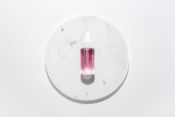 istock Face oil serum on marble circle white background 1706003656