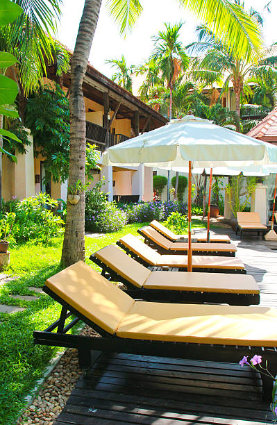 istock Beach chairs and umbrella side swimming pool 170600773