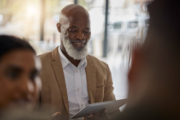 istock Black man, tablet or boss in meeting for business growth, strategy or collaboration on project in office. Happy CEO, digital startup or African senior manager planning or working on online marketing 1706007856