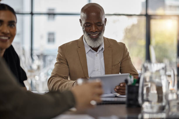 istock Business people, tablet or CEO in meeting for team idea, strategy or collaboration on project in office. Happy, digital startup company or senior manager planning or working on online marketing goals 1706007869