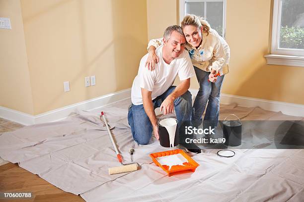 Couple Painting Home Interior Stock Photo - Download Image Now - 30-39 Years, 35-39 Years, 40-44 Years