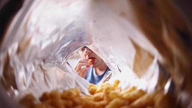 Young Man Eating Flips From The Bag's POV