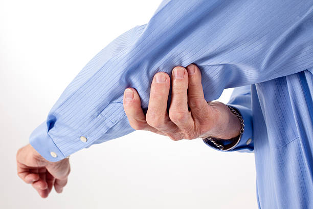 Senior man rubbing Elbow in pain