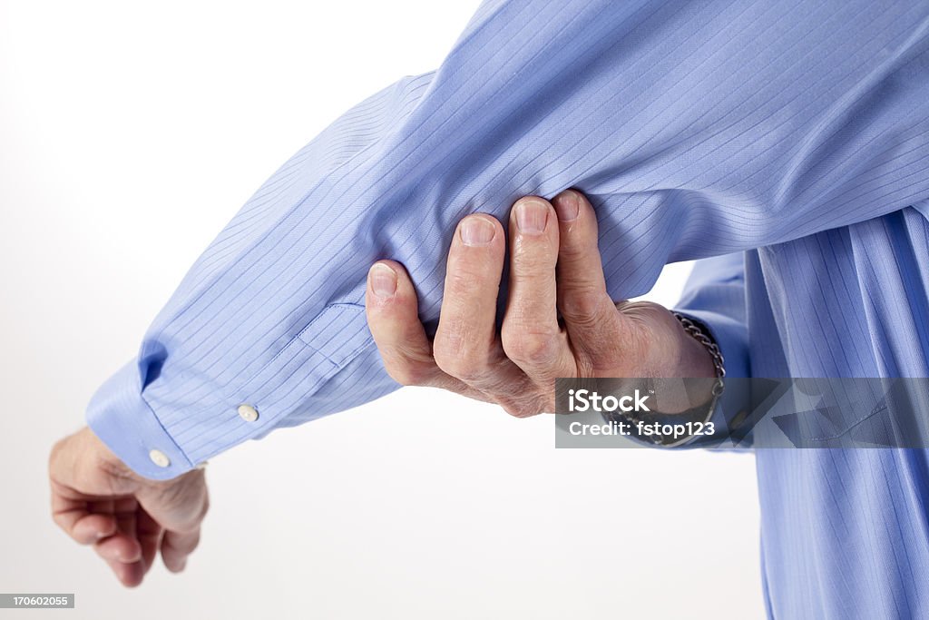 Senior man rubbing Elbow in pain Senior man rubbing his painful elbow. 60-64 Years Stock Photo