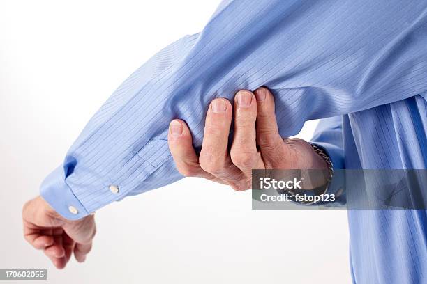 Senior Man Rubbing Elbow In Pain Stock Photo - Download Image Now - 60-64 Years, 60-69 Years, Adult