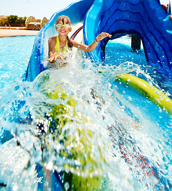 istock Little girl coming down a water slide 170602058