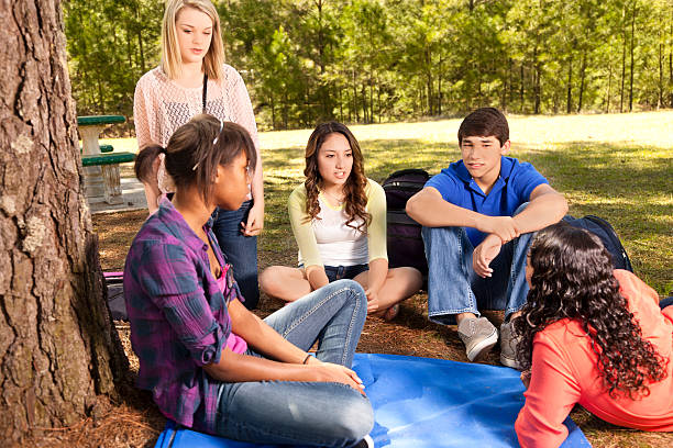 istock Teenagers:  Multi ethnic group of friends enjoying visiting in park 170602229