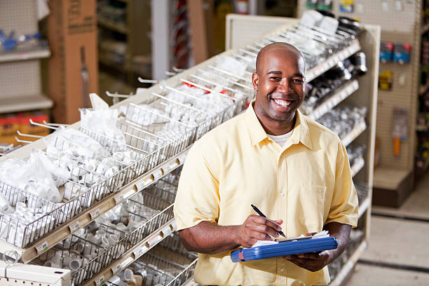 Worker in hardware store taking inventory stock photo