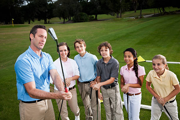 istock Golf pro with group of children on driving range 170602471