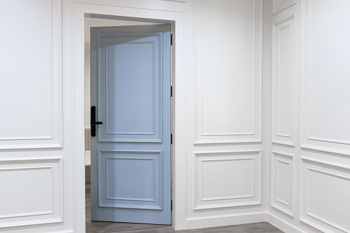 Elegant white wooden walls and door in a large house