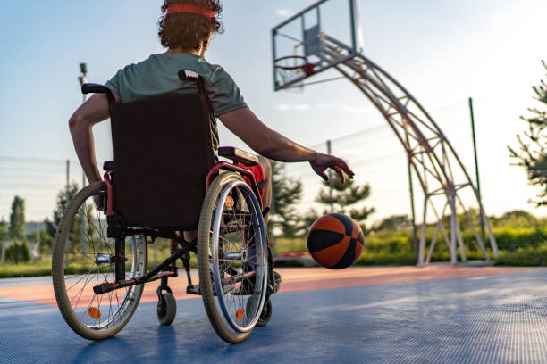 istock Man in wheelchair playing basketball 1706034231