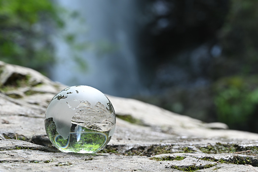 A lensball on little stones at the water of a lake in Bavaria, Germany