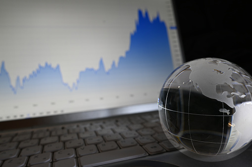 Glass globe with graphs of stock prices