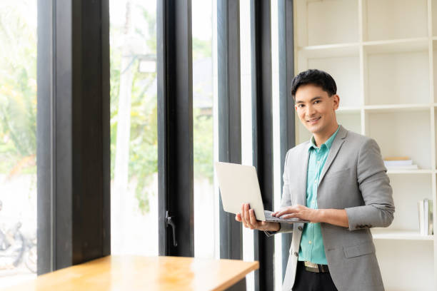 istock Asian businessman working at office with laptop and documents on table Work in the workplace, business documents, financial planning concepts 1706047479