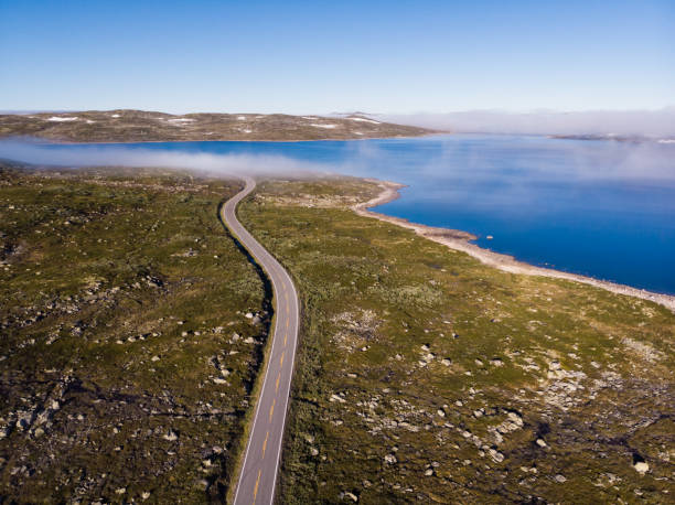 istock Road crossing Hardangervidda plateau, Norway. Aerial view. 1706051230