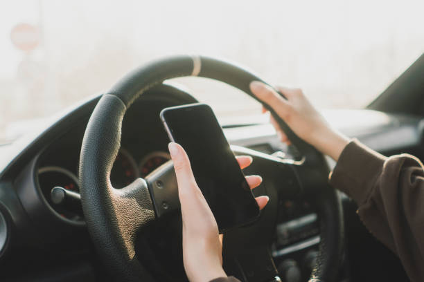 istock careless female driver using smarphone in the car driver seat 1706056029